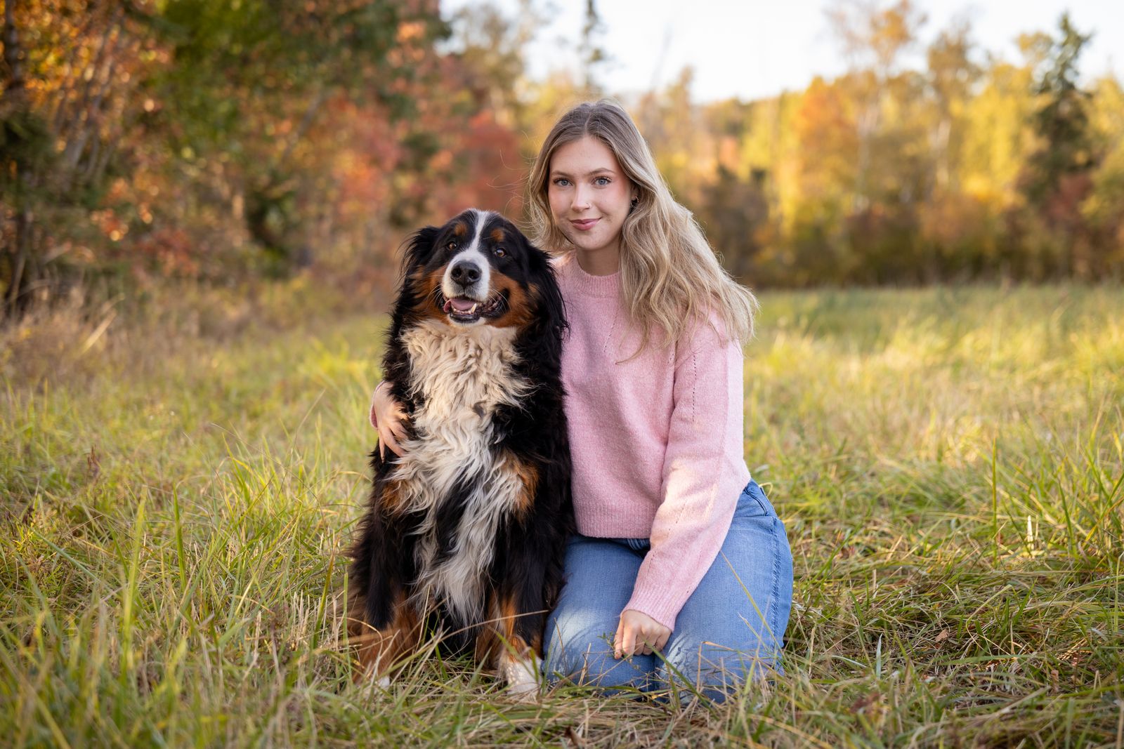 Bernese Mountain Dog resting beside children at home